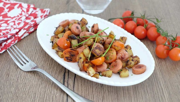Plato de chorizo tableño sobre mesa de madera y junto a servilleta y tenedor.