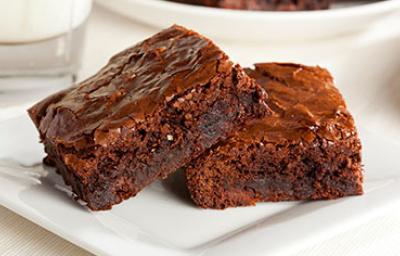 Dos brownies sobre un plato blanco, una de las recetas con chocolate más famosas. Dos brownies sobre un plato blanco, una de las recetas con chocolate más famosas.