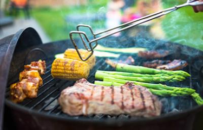 Las pinzas son un utensilio para un asado que no puede faltar. Asado de carne y vegetales, con pinzas para darles vuelta, un utensilio muy importante.