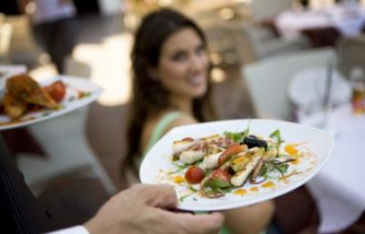 Exquisito y elegante platillo de cualquiera de los tipos de calamar con vegetales siendo llevado a la mesa.
