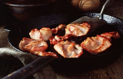 Espátulas de metal cocinando Bacon.