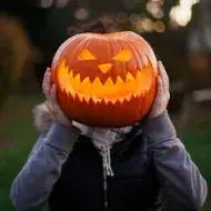 Calabaza de Halloween sobre el cuerpo de una persona.  