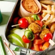 Lonchera con brochetas de vegetales y frutas frescas para alimentación escolar